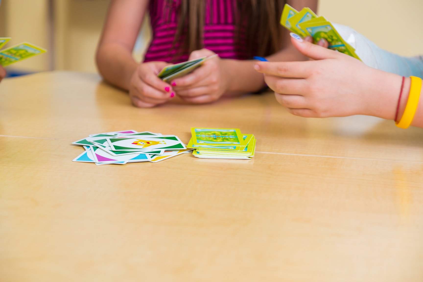 School children playing card game